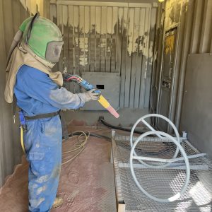 A Man Sandblasting