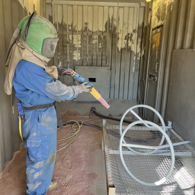 The Side of a Man Sandblasting