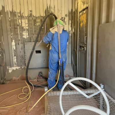 The Back of a Man Sandblasting